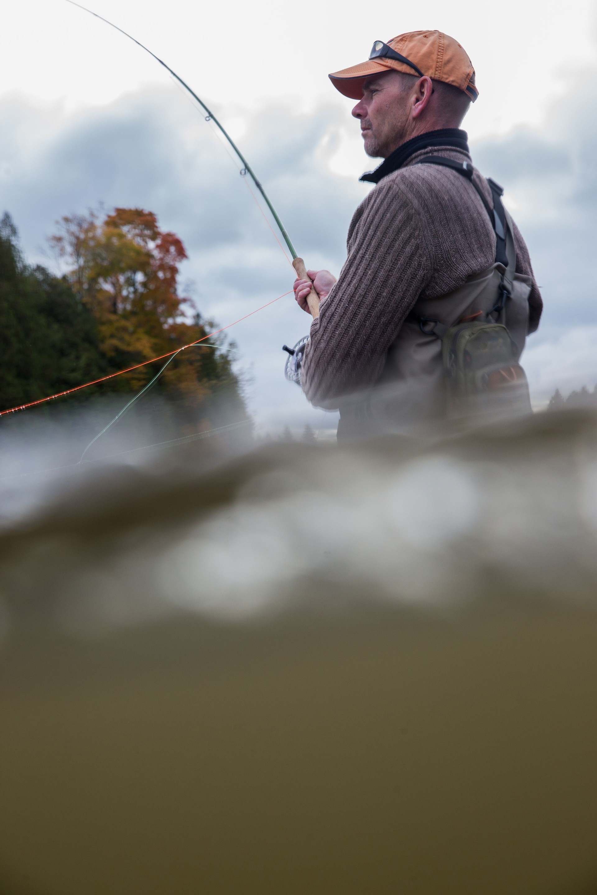 Man fly fishing in the fall in a river